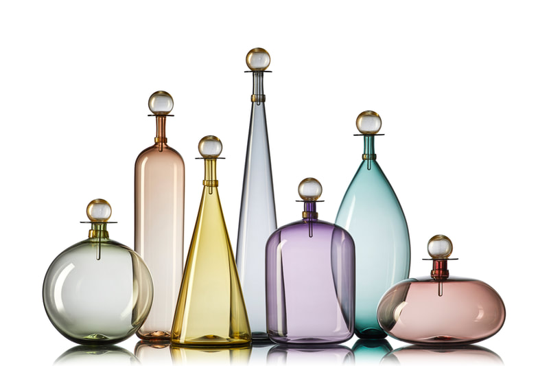 Handblown glass bottles in colored glass inspired by midcentury decanter designs. By Vetro Vero